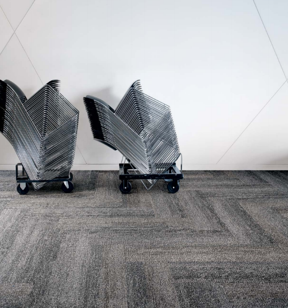 stacked chairs in a showroom interior having with carpet tiles on floors